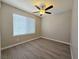 Comfortable bedroom with wood-look floors, a ceiling fan, and a window at 3038 Tarpon Dr # 203, Las Vegas, NV 89120