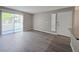 Bright living room with sliding glass doors, wood-look flooring, and neutral paint, ready for your personal touches at 3038 Tarpon Dr # 203, Las Vegas, NV 89120
