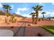 Desert landscaped backyard with stone pathway, low-maintenance plants, and distant mountain scenery at 3157 Faiss Dr, Las Vegas, NV 89134