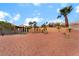 Spacious desert backyard with covered patio, artificial grass, and drought-tolerant plants at 3157 Faiss Dr, Las Vegas, NV 89134