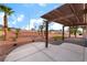 Expansive backyard patio with pergola, showcasing desert landscaping and ample open space at 3157 Faiss Dr, Las Vegas, NV 89134
