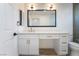 Bright bathroom with white cabinetry, quartz countertop, and modern vanity mirror at 3157 Faiss Dr, Las Vegas, NV 89134