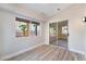 Bright bonus room featuring wood floors, large windows, and glass sliding door to backyard at 3157 Faiss Dr, Las Vegas, NV 89134