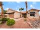 Charming single-story home featuring desert landscaping with rock features and mature palm trees at 3157 Faiss Dr, Las Vegas, NV 89134