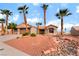 Beautiful single-story home boasting a two-car garage, rock accents and mature palm tree landscaping at 3157 Faiss Dr, Las Vegas, NV 89134