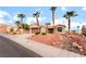 Inviting single-story home showcasing desert landscaping, mature palms, and a convenient two-car garage at 3157 Faiss Dr, Las Vegas, NV 89134