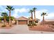 Charming single-story home featuring a two-car garage and desert landscaping with mature palm trees at 3157 Faiss Dr, Las Vegas, NV 89134