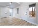 Bright hallway boasts light-colored wood floors, neutral paint, and access to a bathroom at 3157 Faiss Dr, Las Vegas, NV 89134