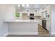 Bright, white kitchen with modern appliances and breakfast bar at 3157 Faiss Dr, Las Vegas, NV 89134