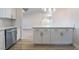 Bright kitchen featuring white cabinets and stainless steel appliances and breakfast bar at 3157 Faiss Dr, Las Vegas, NV 89134