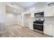 Modern kitchen with stainless steel appliances and white cabinets at 3157 Faiss Dr, Las Vegas, NV 89134