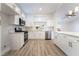 Modern kitchen with stainless steel appliances and white cabinets and breakfast bar at 3157 Faiss Dr, Las Vegas, NV 89134
