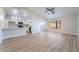 Open-concept living space with a view to kitchen, light wood flooring and lots of natural light at 3157 Faiss Dr, Las Vegas, NV 89134