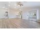 Bright living room with updated light fixtures, light wood floors and neutral paint throughout at 3157 Faiss Dr, Las Vegas, NV 89134