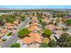 Expansive aerial view of a desert neighborhood featuring lush landscaping and Spanish tile roofs at 3221 Palmdesert Way, Las Vegas, NV 89120