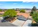 Aerial view of the home showcasing the manicured front yard, three car garage, and desert landscape at 3221 Palmdesert Way, Las Vegas, NV 89120
