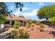 Desert landscaped backyard with mature trees and a covered patio for outdoor living at 3221 Palmdesert Way, Las Vegas, NV 89120