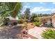 Backyard featuring mature trees, desert landscaping and a covered patio at 3221 Palmdesert Way, Las Vegas, NV 89120