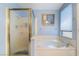 Bright bathroom showcasing a luxurious soaking tub with window and a separate glass-enclosed shower at 3221 Palmdesert Way, Las Vegas, NV 89120
