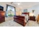 Cozy bedroom with a large window, plush carpeting, and a stylish wooden bed frame at 3221 Palmdesert Way, Las Vegas, NV 89120