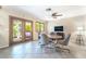 Bright dining area featuring a ceiling fan, tile flooring, and patio access at 3221 Palmdesert Way, Las Vegas, NV 89120
