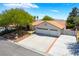 Charming one-story home with a three-car garage, tiled roof, and desert landscaping at 3221 Palmdesert Way, Las Vegas, NV 89120