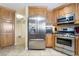 Updated kitchen with stainless steel appliances, granite countertops, and custom wood cabinets at 3221 Palmdesert Way, Las Vegas, NV 89120