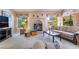 Inviting living room featuring a brick fireplace, comfortable seating, and natural light at 3221 Palmdesert Way, Las Vegas, NV 89120