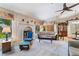 Inviting living room featuring a painted brick fireplace, plush carpeting and abundant natural light at 3221 Palmdesert Way, Las Vegas, NV 89120