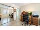 Spacious office area featuring a mirrored closet, tile floors, and a workspace with traditional wooden desks at 3221 Palmdesert Way, Las Vegas, NV 89120