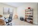 Well-lit office featuring tile flooring, large window, a desk, and wooden shelving unit for storage at 3221 Palmdesert Way, Las Vegas, NV 89120