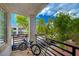 Balcony view featuring black iron railing, bike, exterior views of the building and surrounding trees at 3318 N Decatur Blvd # 2073, Las Vegas, NV 89130