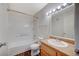 Inviting bathroom with tiled shower-tub, laminate floors, and a vanity with granite counters at 3318 N Decatur Blvd # 2073, Las Vegas, NV 89130
