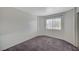 Bedroom features neutral walls, gray carpet, and a window at 3318 N Decatur Blvd # 2073, Las Vegas, NV 89130