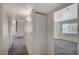 Hallway featuring neutral carpet, white walls, closet, and an entry way into a bright room with a large window at 3318 N Decatur Blvd # 2073, Las Vegas, NV 89130