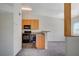 A functional kitchen flows into the living area, offering ample storage and modern black appliances at 3318 N Decatur Blvd # 2073, Las Vegas, NV 89130