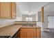 Kitchen area with light stone countertops and stainless steel double sink and an opening to the living room at 3318 N Decatur Blvd # 2073, Las Vegas, NV 89130