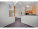 A living room area with neutral walls and carpet leading to a partial view of the kitchen area with light colored cabinets at 3318 N Decatur Blvd # 2073, Las Vegas, NV 89130