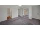 Primary bedroom with gray carpets, and views of an ensuite bathroom and mirrored closet doors at 3318 N Decatur Blvd # 2073, Las Vegas, NV 89130