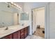 Bathroom with a double sink vanity, modern lighting, and access to a separate shower and toilet area at 3924 Quiet Pine St # 201, Las Vegas, NV 89108