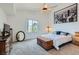 Bright bedroom with carpet, a ceiling fan, city art, a storage chest, and a decorative mirror at 3924 Quiet Pine St # 201, Las Vegas, NV 89108