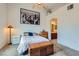 Large bedroom featuring carpet, vaulted ceiling, city art, and easy access to the ensuite bathroom at 3924 Quiet Pine St # 201, Las Vegas, NV 89108