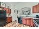Cozy kitchen featuring wood cabinets, black appliances, and an open design leading to other living spaces at 3924 Quiet Pine St # 201, Las Vegas, NV 89108