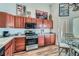 Spacious kitchen with wooden cabinets, stainless steel appliances, and an eat-in dining area at 3924 Quiet Pine St # 201, Las Vegas, NV 89108