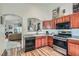 Well-lit kitchen with stainless steel appliances, wood cabinets, and an open layout to the living room at 3924 Quiet Pine St # 201, Las Vegas, NV 89108