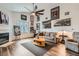 Living room showcasing a fireplace, hardwood floors, neutral-toned sofas, and artistic decor at 3924 Quiet Pine St # 201, Las Vegas, NV 89108