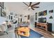 A open floorplan living room with hardwood floors, ceiling fan, and media center at 3924 Quiet Pine St # 201, Las Vegas, NV 89108
