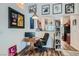 Bright office space with a wooden desk, decorative artwork, and seamless access to the kitchen area at 3924 Quiet Pine St # 201, Las Vegas, NV 89108