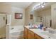 Bright bathroom featuring a double sink vanity, soaking tub, and separate shower at 3975 N Hualapai Way # 147, Las Vegas, NV 89129