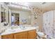 Charming bathroom with butterfly decor, vanity, and shower-tub combination at 3975 N Hualapai Way # 147, Las Vegas, NV 89129